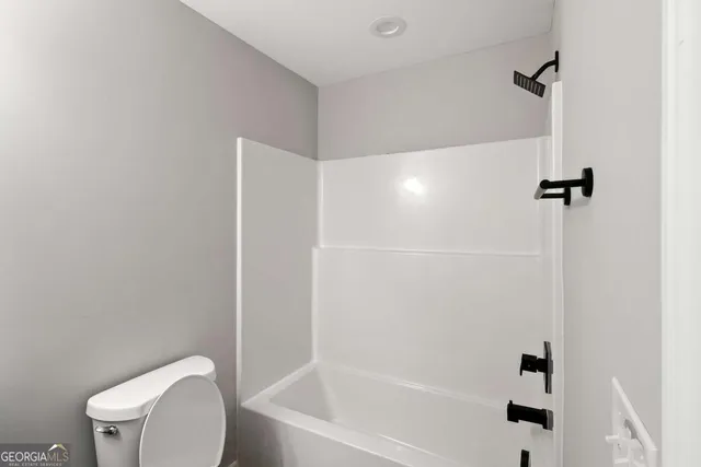 a bathroom with a toilet and a bathtub