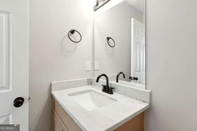 a bathroom with a sink and mirror