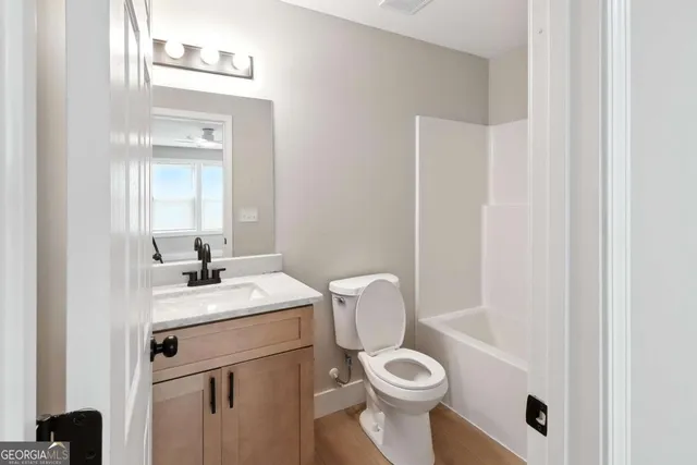 a white toilet sitting next to a bathroom sink