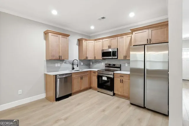 a kitchen with a refrigerator sink and microwave