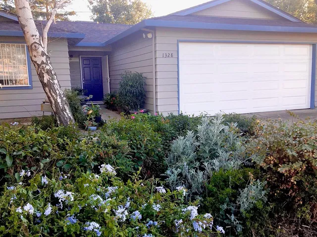 a view of a hallway and closet with wooden floor