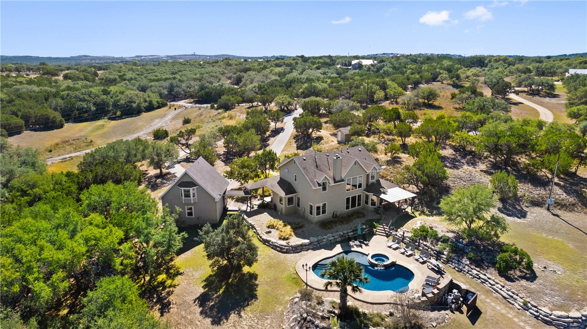 an aerial view of a house with a swimming pool yard and outdoor seating