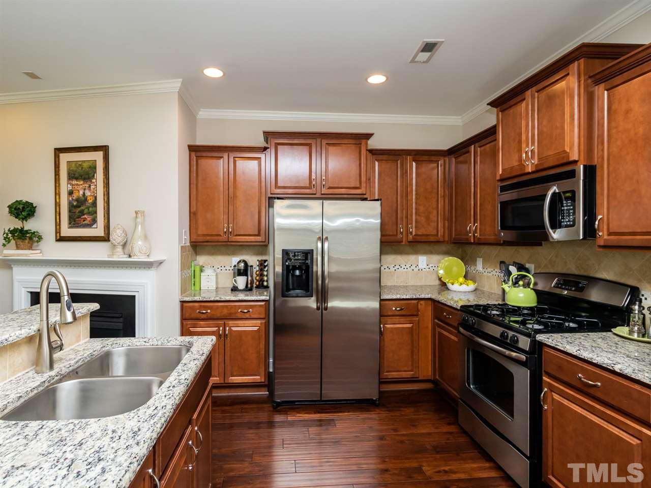 1589 Fullerton Place Raleigh, NC 27607 - Photo 12 of 25 a kitchen with granite countertop a sink stainless steel appliances and cabinets