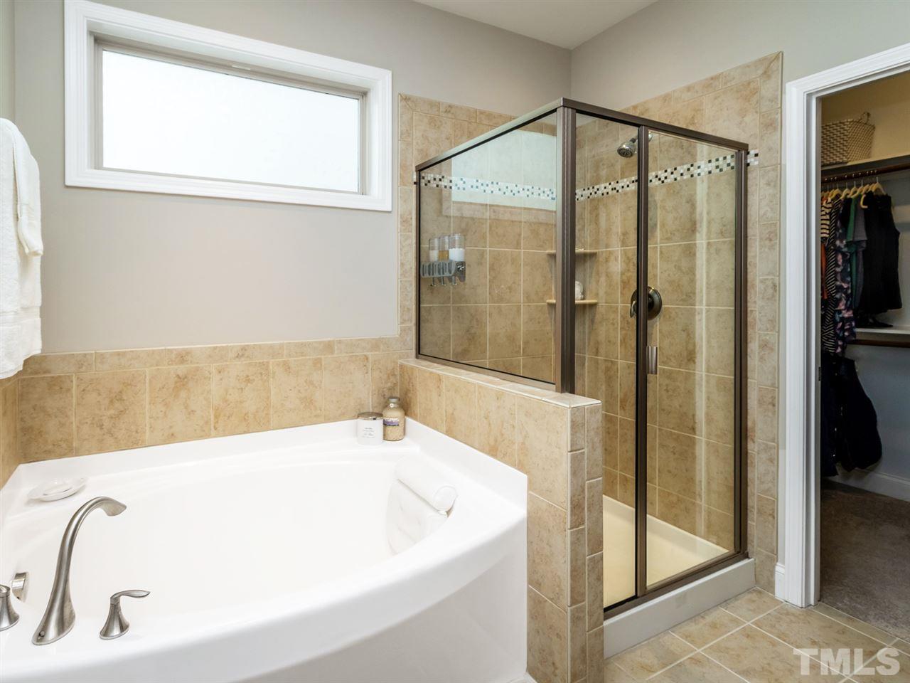 1589 Fullerton Place Raleigh, NC 27607 - Photo 15 of 25 a bathroom with a bathtub and a shower