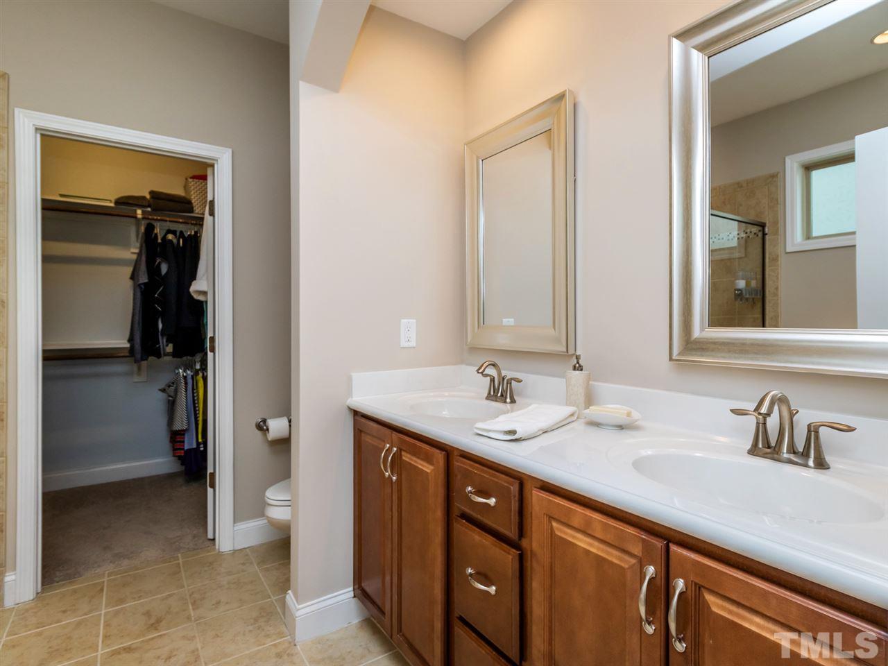 1589 Fullerton Place Raleigh, NC 27607 - Photo 16 of 25 a spacious bathroom with a sink and mirror