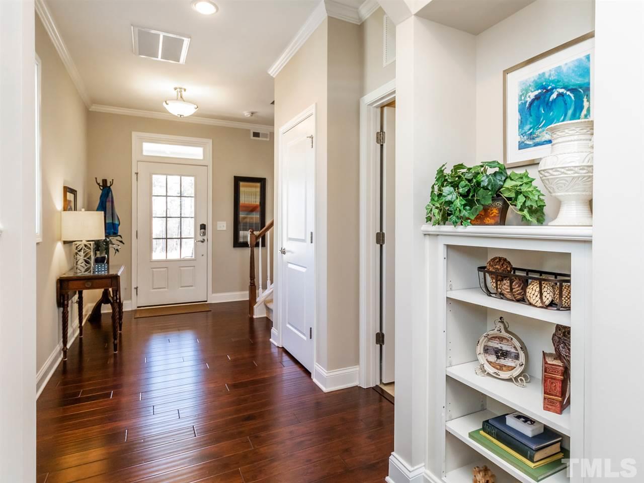 1589 Fullerton Place Raleigh, NC 27607 - Photo 4 of 25 a view of a hallway to room with wooden floor and furniture