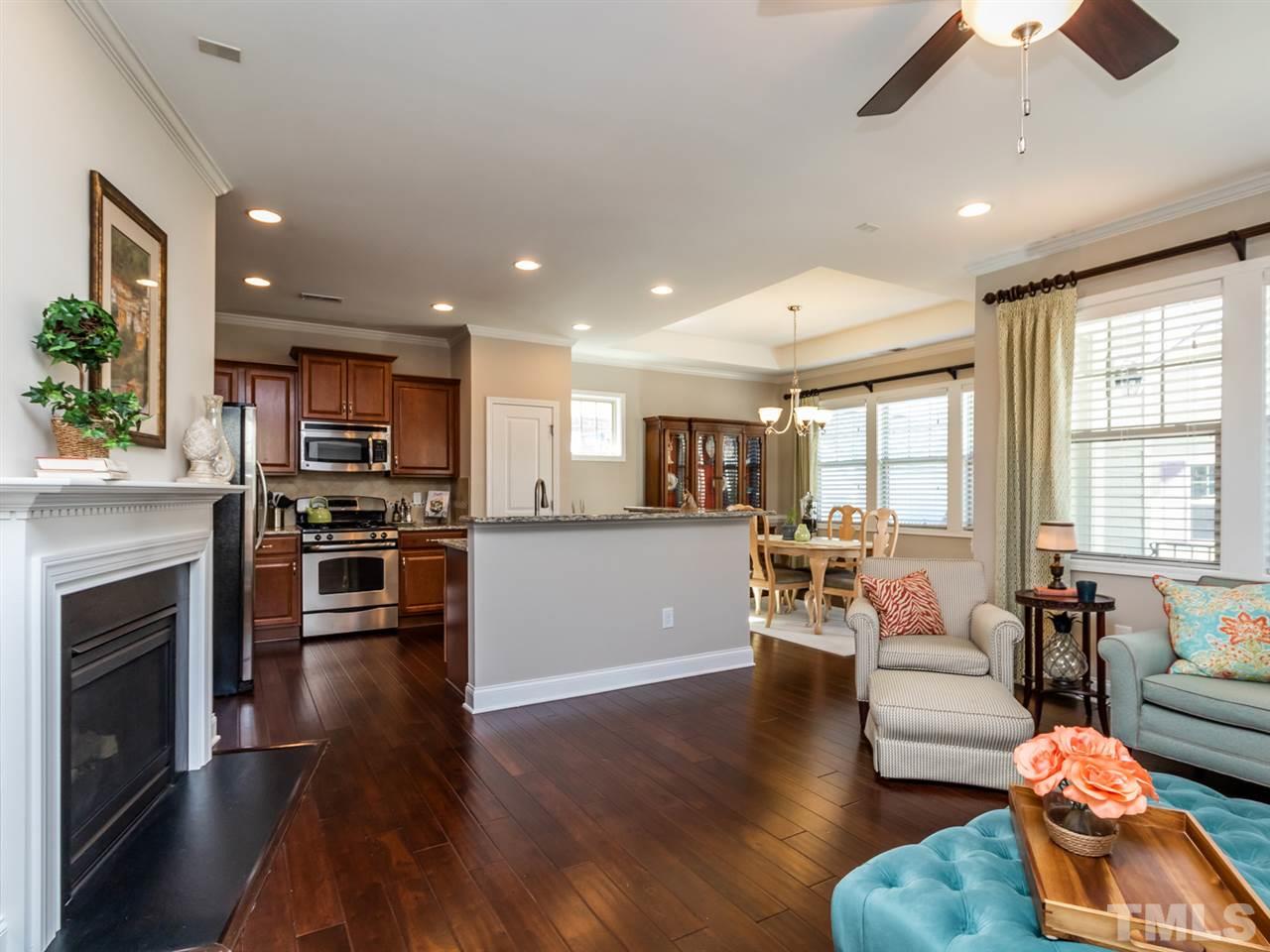 1589 Fullerton Place Raleigh, NC 27607 - Photo 8 of 25 a living room with furniture wooden floor and a fireplace