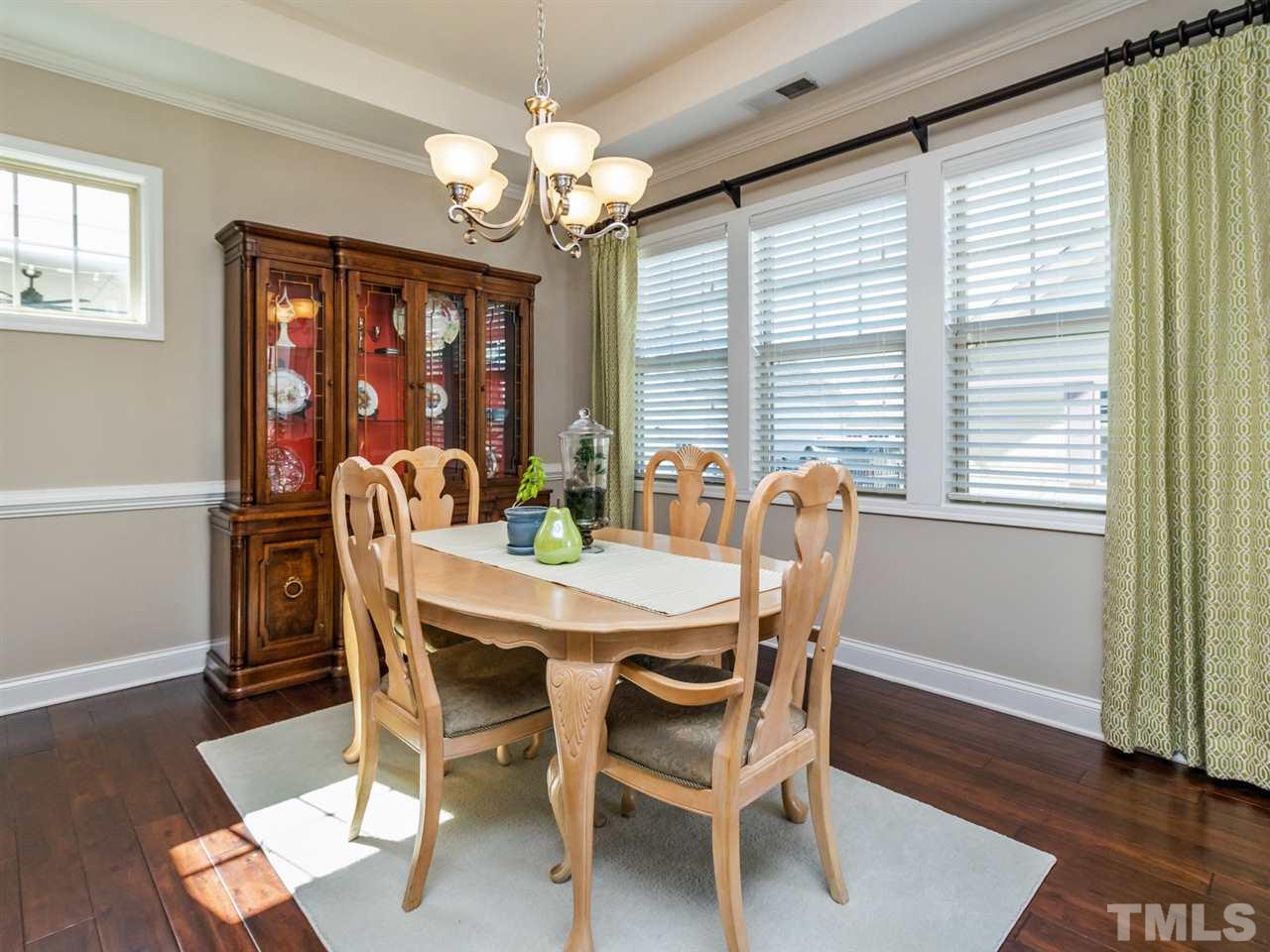 1589 Fullerton Place Raleigh, NC 27607 - Photo 9 of 25 a view of a dining room with furniture wooden floor and chandelier