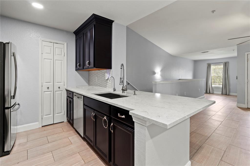 8911 Manor Loop, Unit 204 Lakewood Ranch, FL 34202 - Photo 14 of 45 a kitchen with a sink and a refrigerator