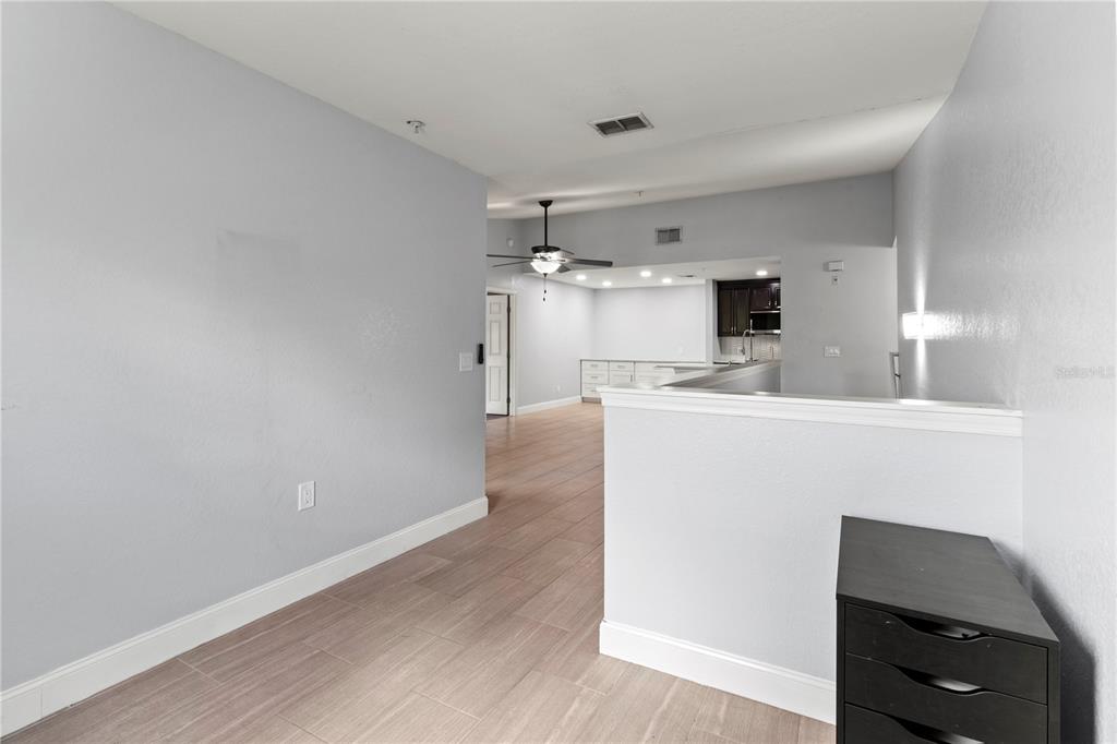 8911 Manor Loop, Unit 204 Lakewood Ranch, FL 34202 - Photo 20 of 45 a kitchen with kitchen island a sink appliances and cabinets