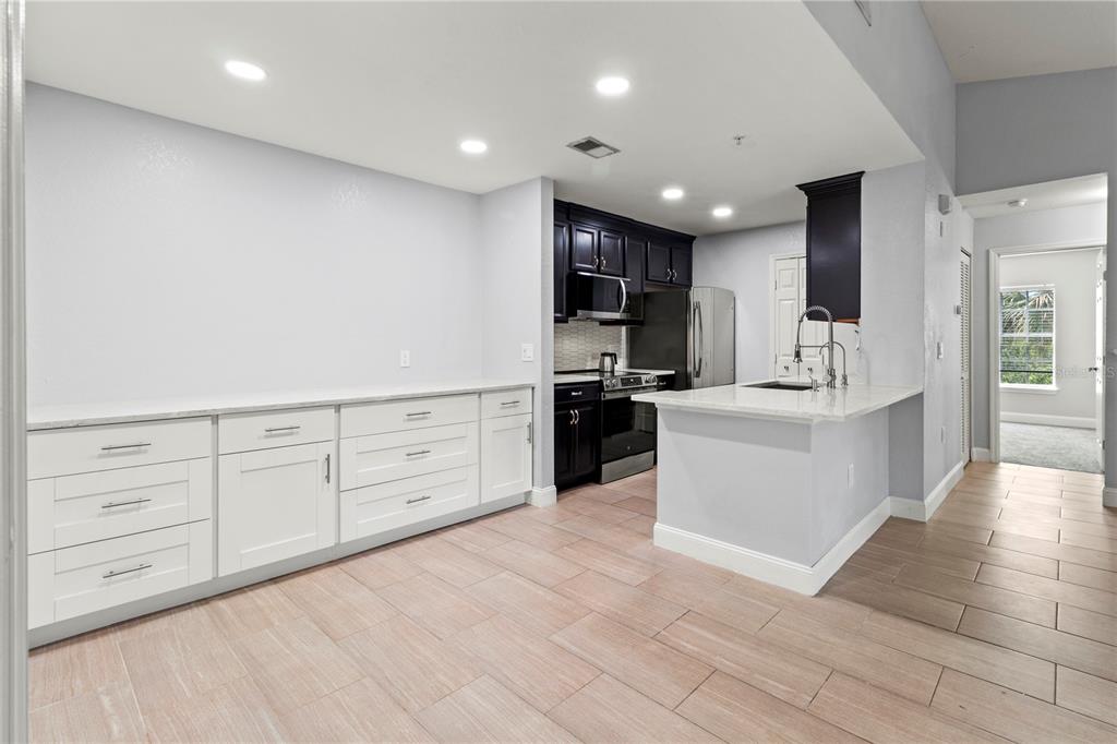 8911 Manor Loop, Unit 204 Lakewood Ranch, FL 34202 - Photo 21 of 45 a large white kitchen with cabinets