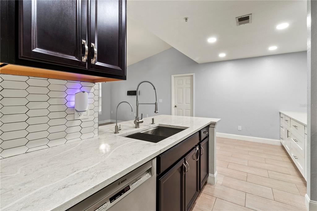 8911 Manor Loop, Unit 204 Lakewood Ranch, FL 34202 - Photo 23 of 45 a kitchen with a sink and cabinets