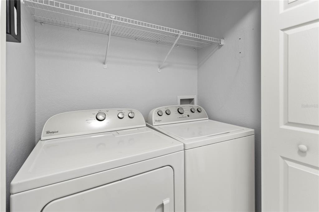 8911 Manor Loop, Unit 204 Lakewood Ranch, FL 34202 - Photo 29 of 45 a utility room with dryer and washer