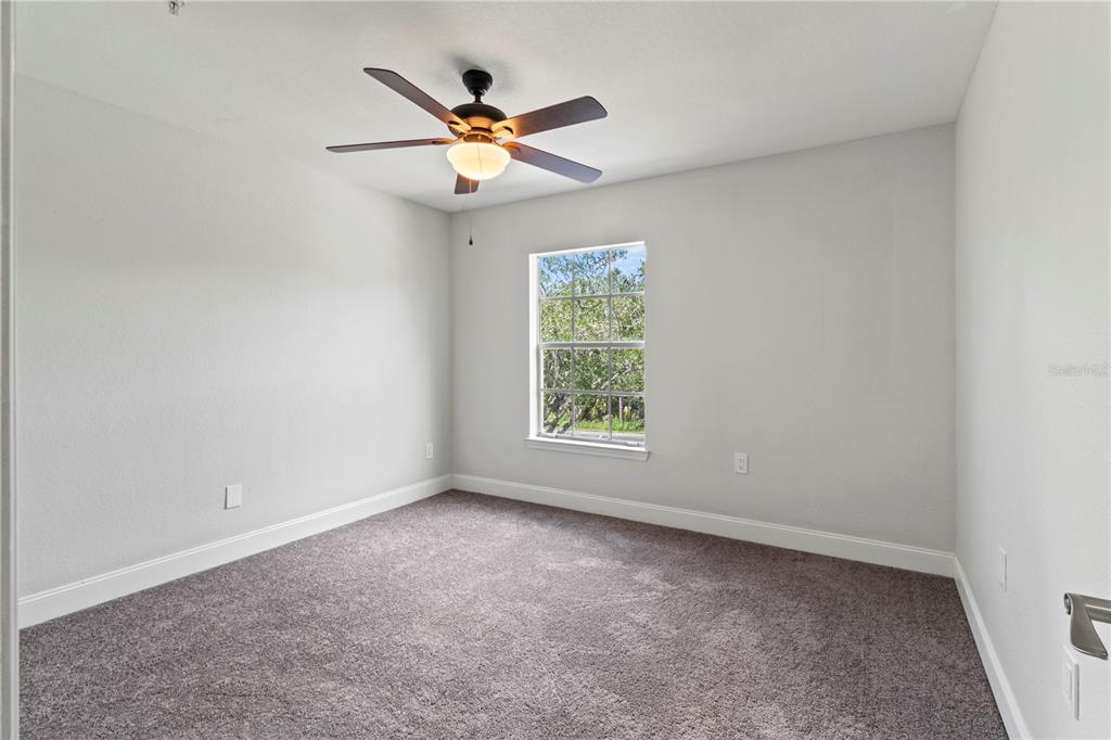 8911 Manor Loop, Unit 204 Lakewood Ranch, FL 34202 - Photo 30 of 45 an empty room with a window and a fan
