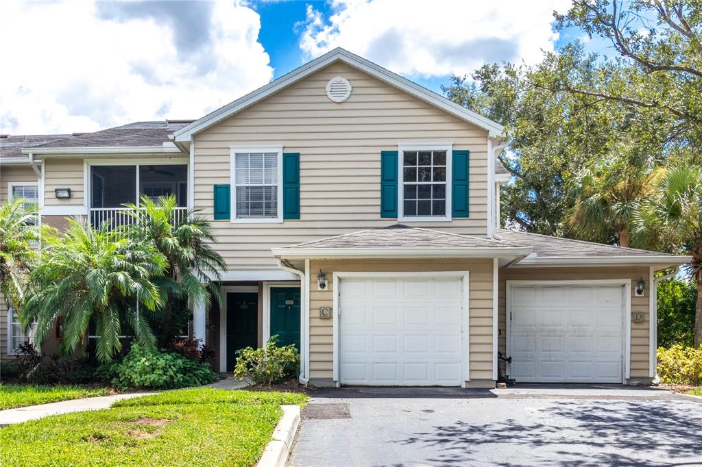 8911 Manor Loop, Unit 204 Lakewood Ranch, FL 34202 - Photo 3 of 45 a front view of a house with garden