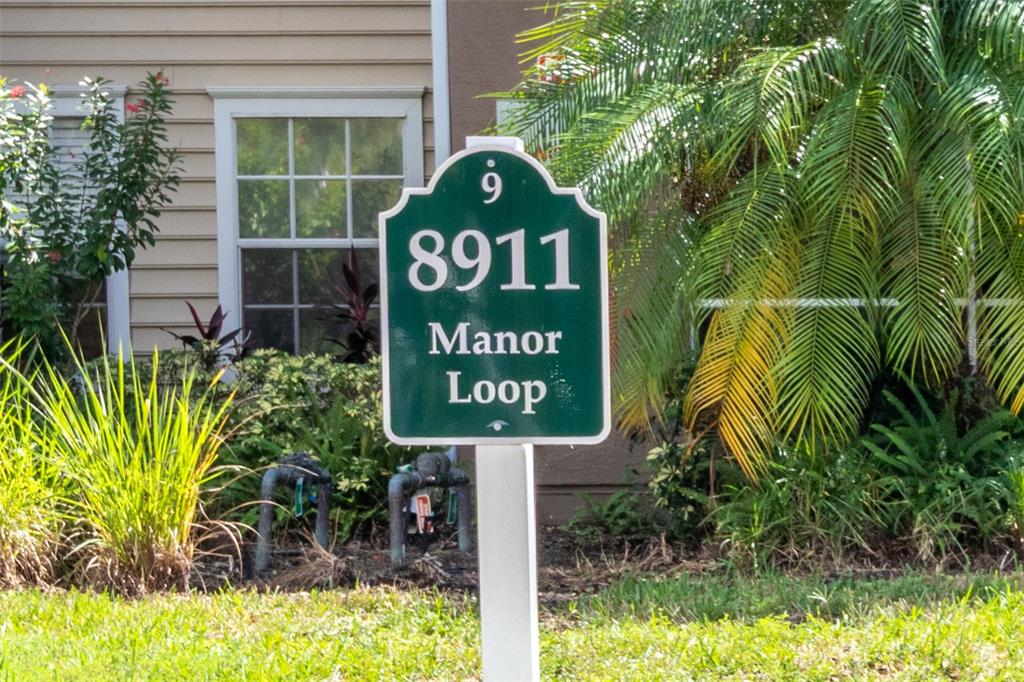 8911 Manor Loop, Unit 204 Lakewood Ranch, FL 34202 - Photo 31 of 45 a sign broad on the side of a brick wall