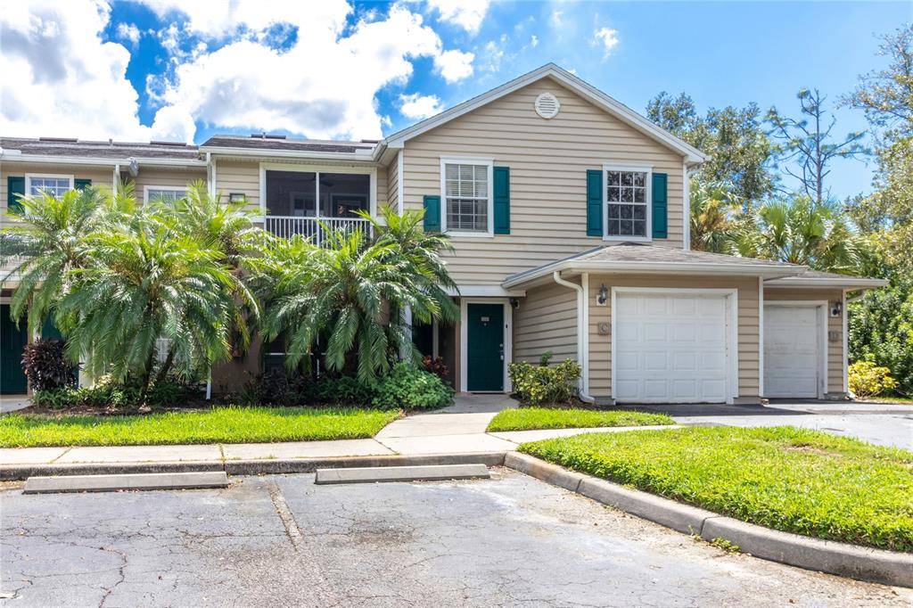 8911 Manor Loop, Unit 204 Lakewood Ranch, FL 34202 - Photo 4 of 45 a front view of a house with garage and yard