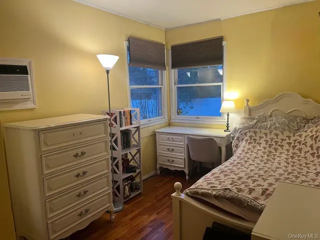 a room with a bed and a dresser