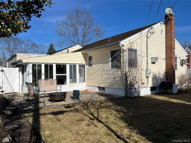 a view of house with backyard porch and sitting area