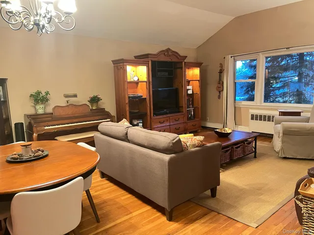 a living room with furniture and a chandelier