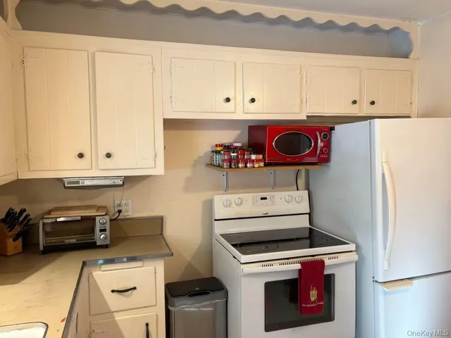 a kitchen with a stove and a white refrigerator