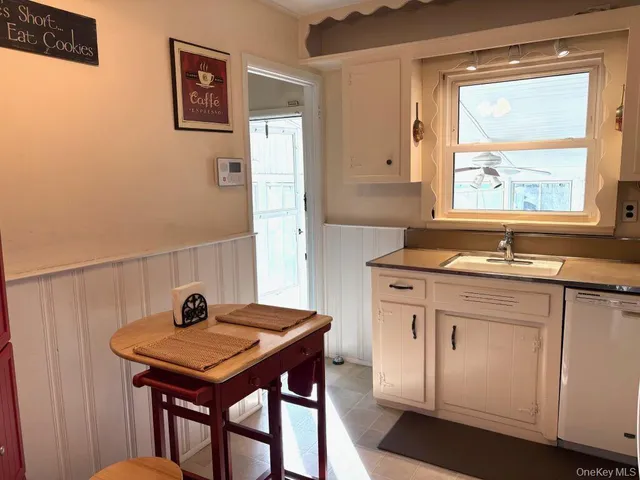 a kitchen with a sink cabinets and a table