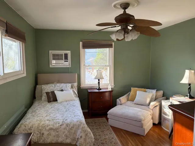 a bedroom with bed and a window