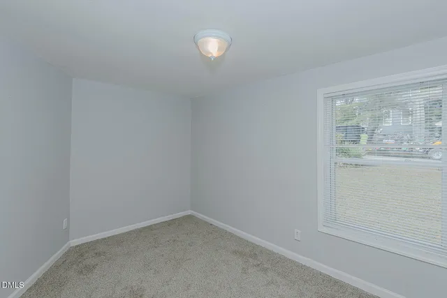 a view of an empty room and closet area