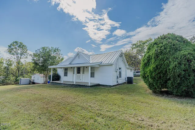 a view of a house with a garden and yard