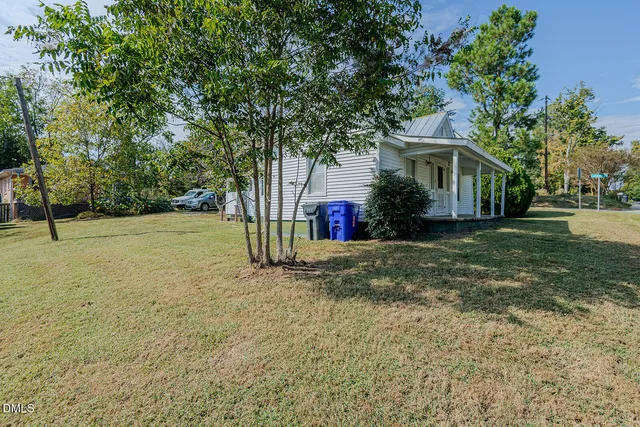 a view of an house with backyard space and garden
