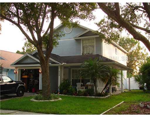 8530 Manassas Road Tampa, FL 33635 - Photo 1 of 1 a view of house with a big yard potted plants and a large tree