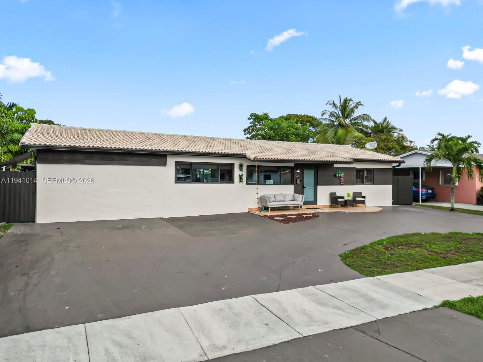 12301 Southwest 28th Street Miami, FL 33175 - Photo 1 of 46 front view of a house with a patio