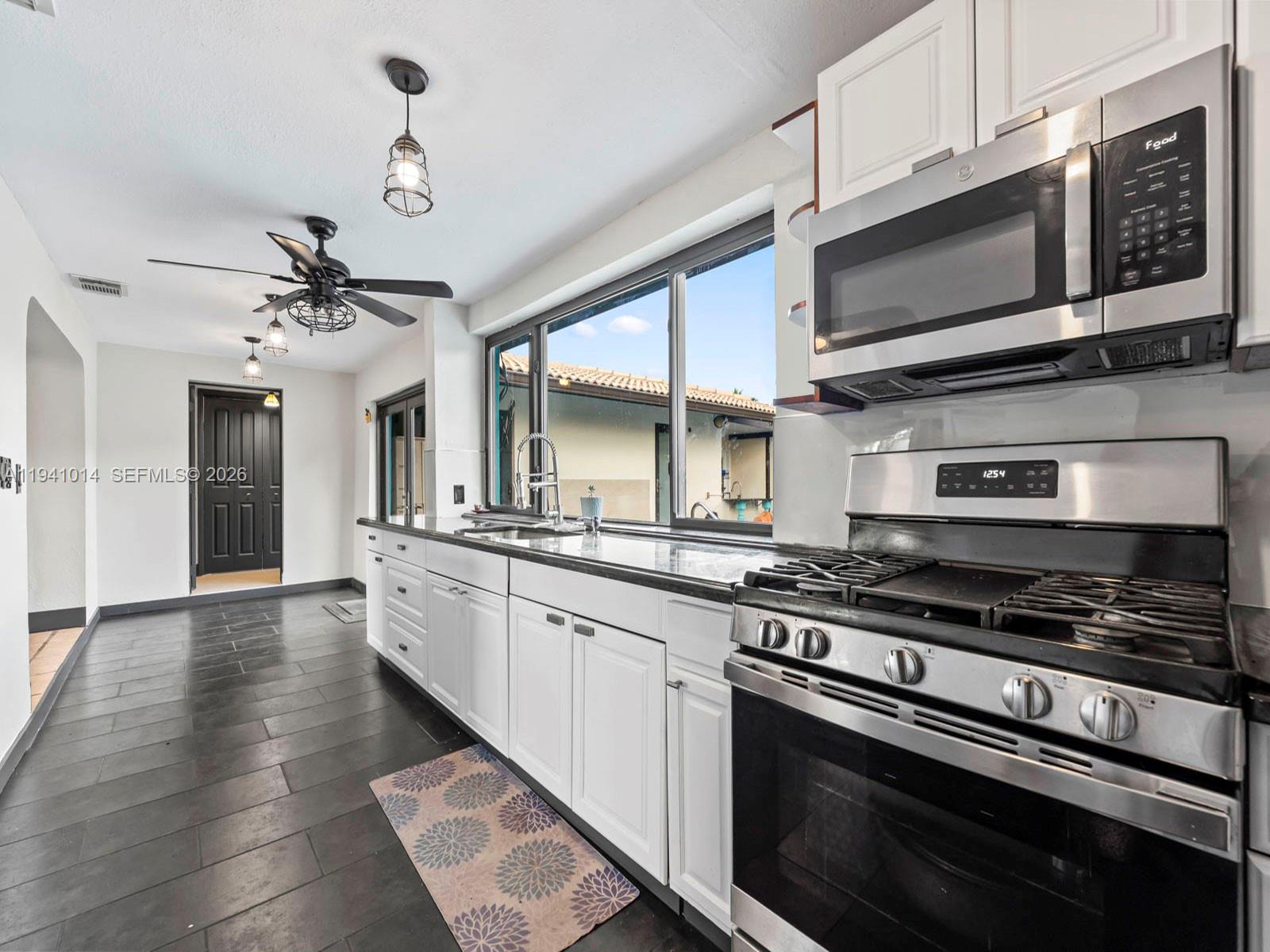 12301 Southwest 28th Street Miami, FL 33175 - Photo 14 of 46 a kitchen with stainless steel appliances granite countertop a stove and a sink