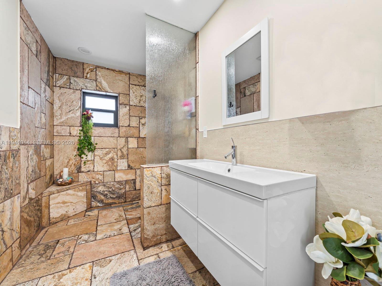 12301 Southwest 28th Street Miami, FL 33175 - Photo 17 of 46 a bathroom with a sink mirror and a bathtub