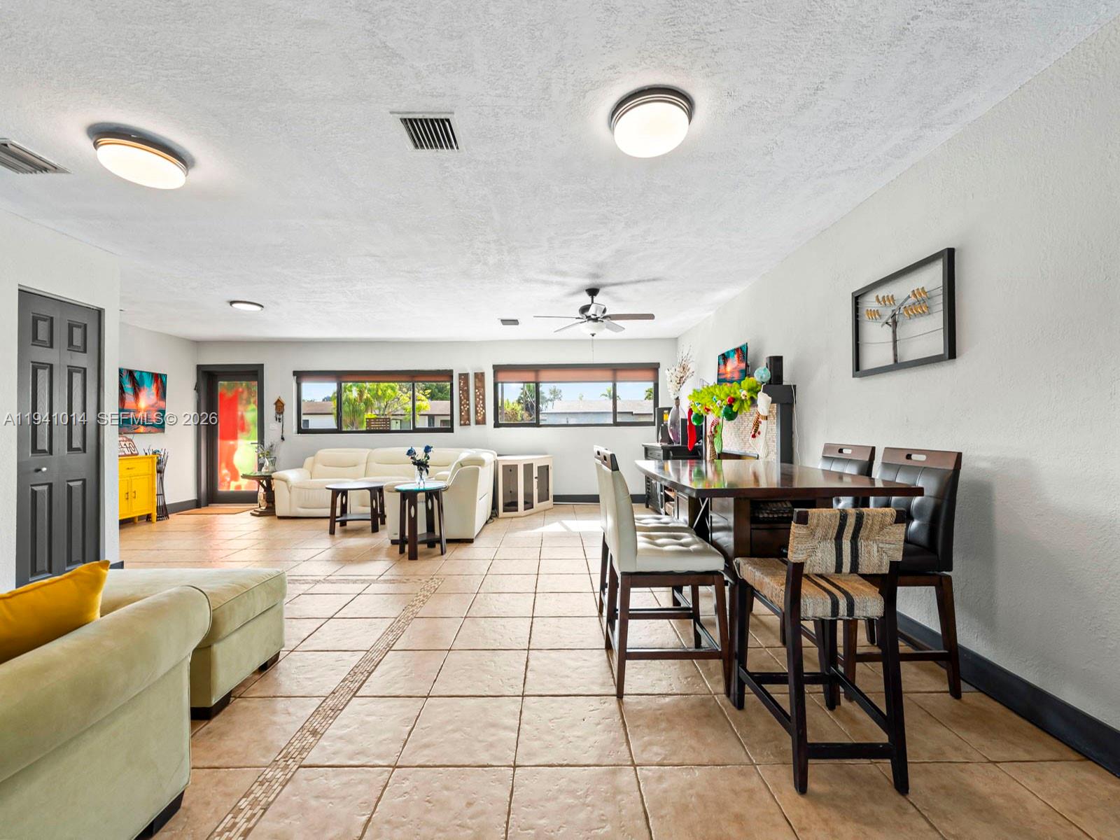 12301 Southwest 28th Street Miami, FL 33175 - Photo 2 of 46 a living room with lots of furniture and white walls