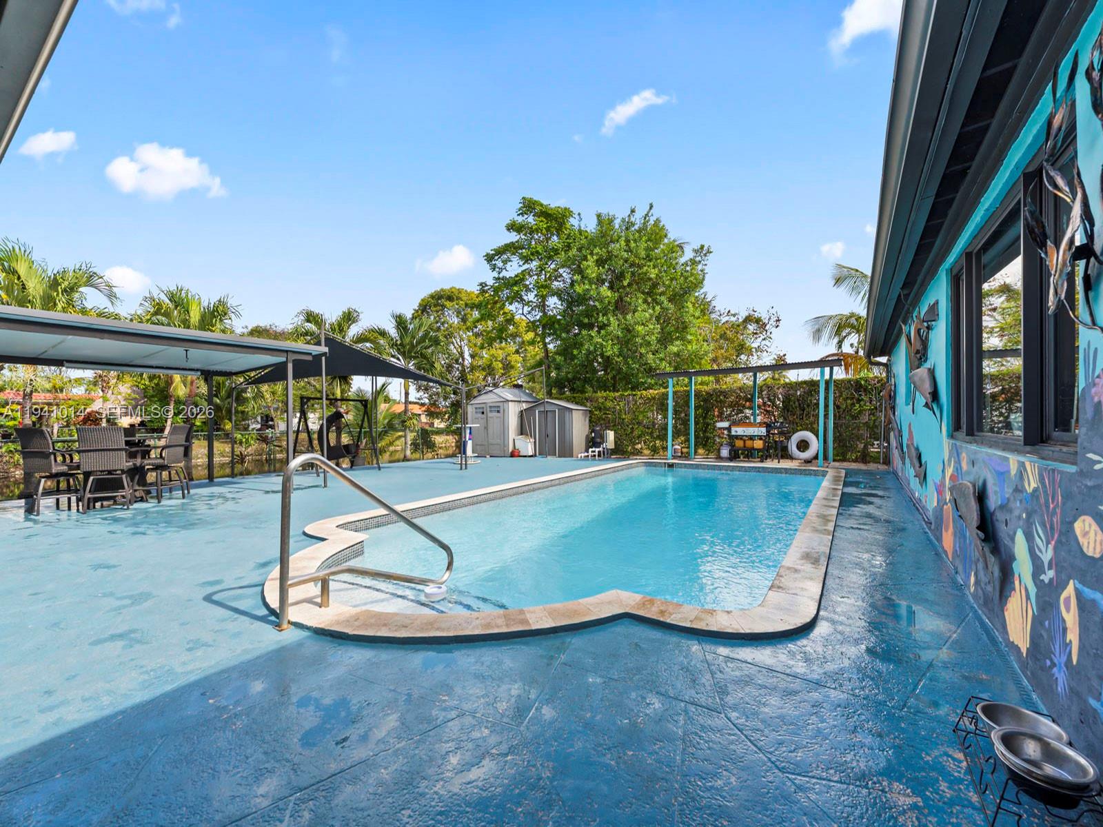 12301 Southwest 28th Street Miami, FL 33175 - Photo 24 of 46 a view of a swimming pool with a patio