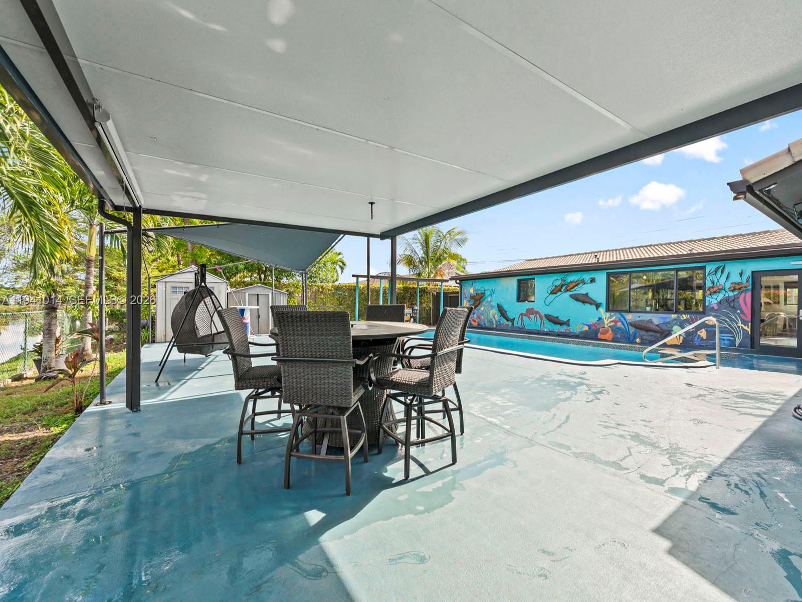 12301 Southwest 28th Street Miami, FL 33175 - Photo 28 of 46 a view of a patio with a table and chairs