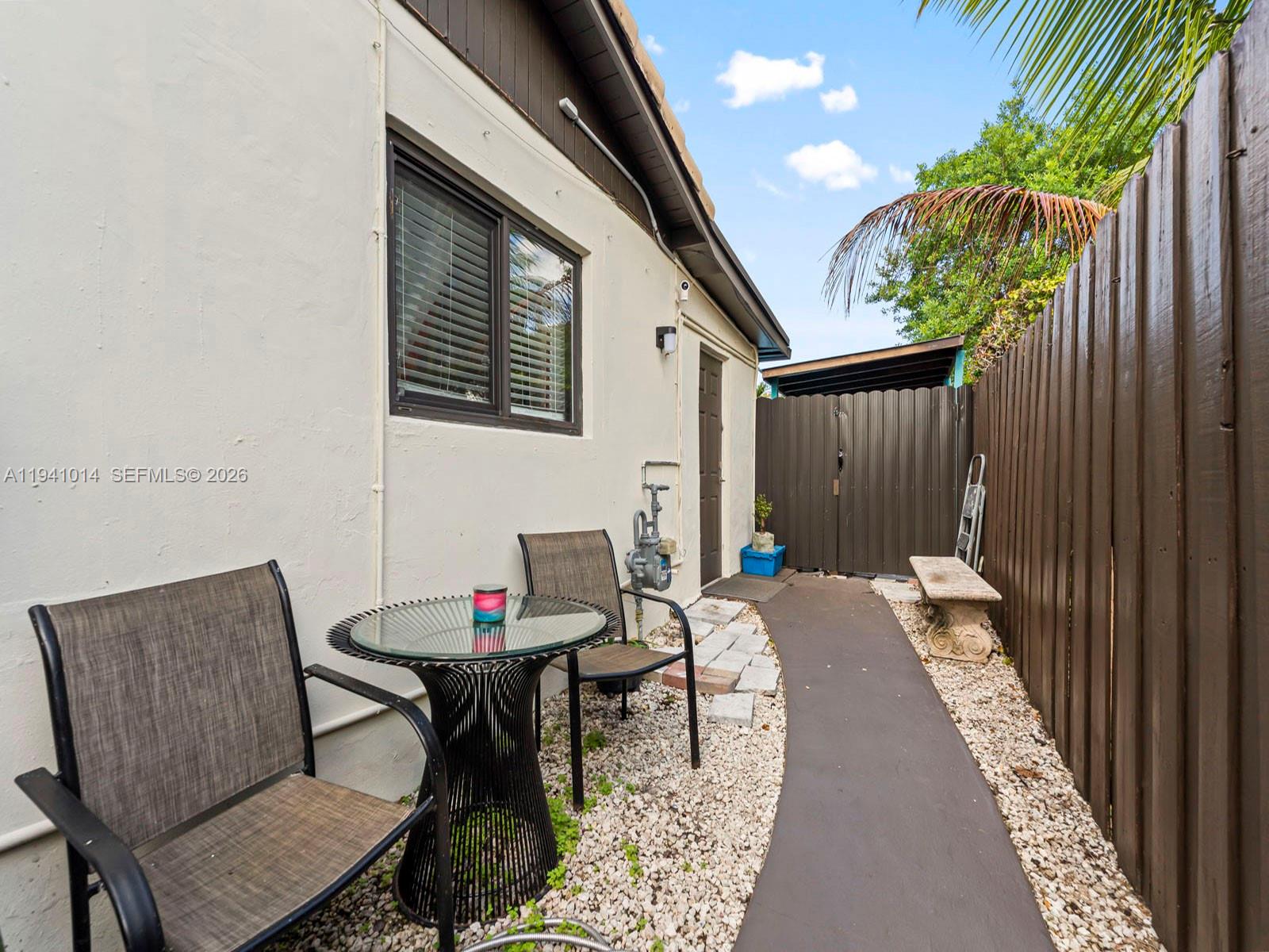 12301 Southwest 28th Street Miami, FL 33175 - Photo 30 of 46 a balcony with table and chairs