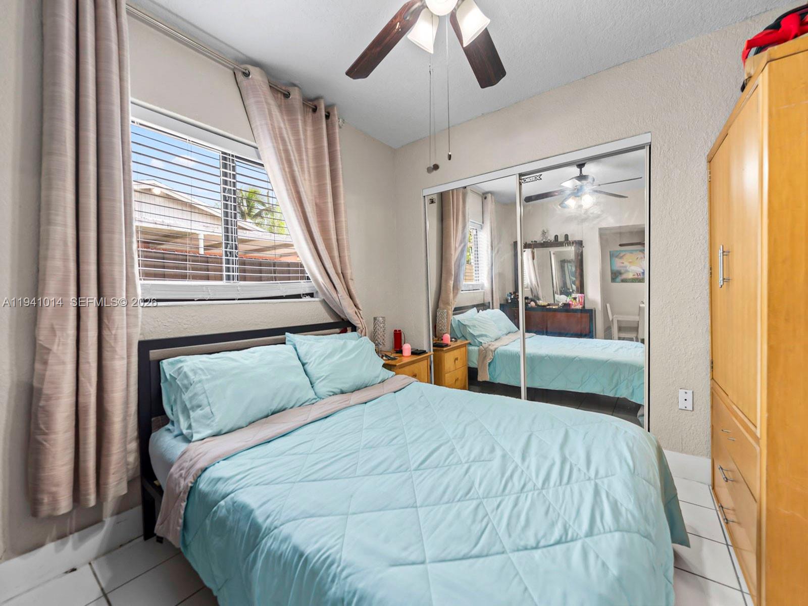 12301 Southwest 28th Street Miami, FL 33175 - Photo 33 of 46 a bedroom with a bed and a mirror