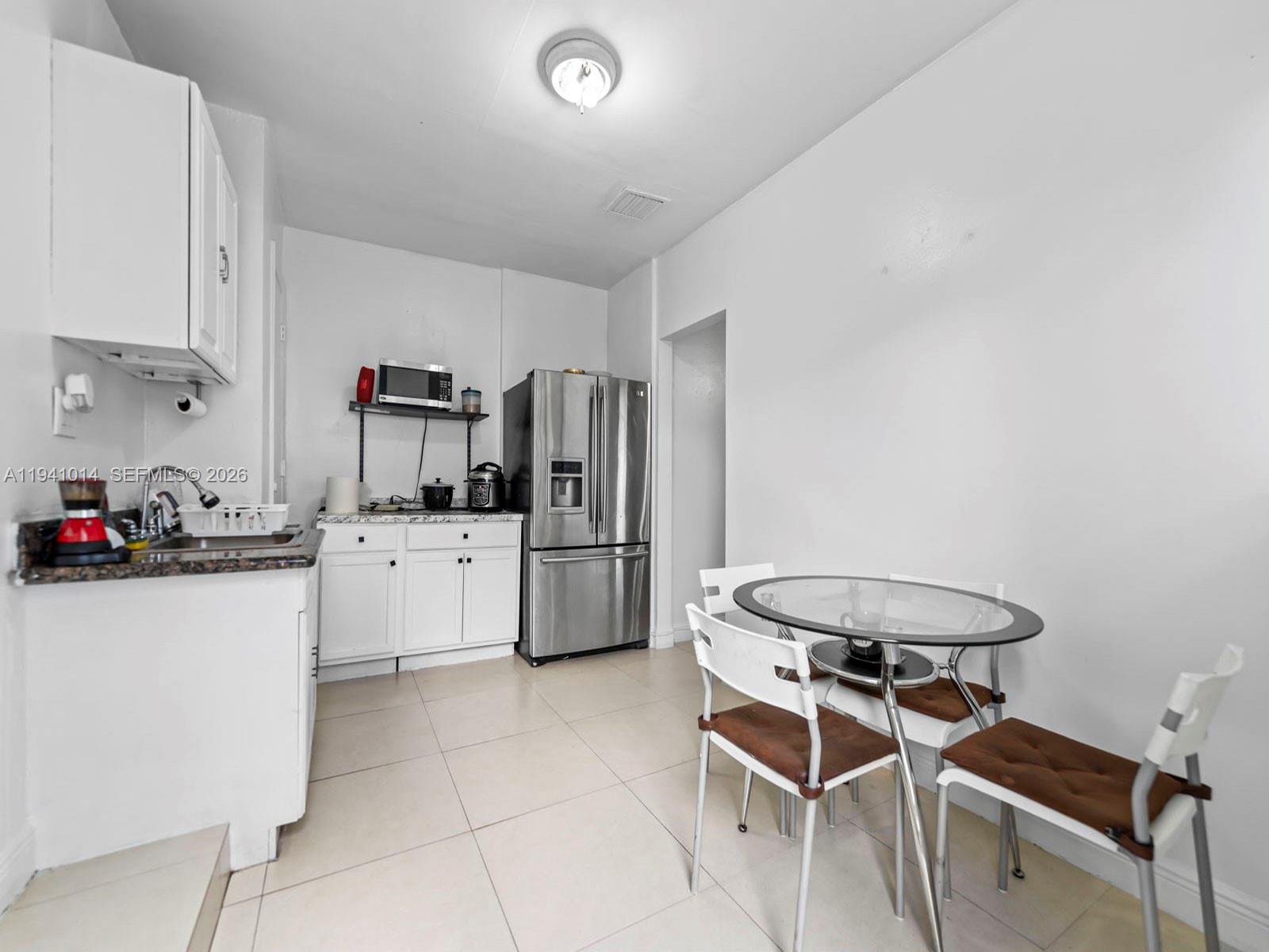 12301 Southwest 28th Street Miami, FL 33175 - Photo 36 of 46 a kitchen with a sink a stove and refrigerator