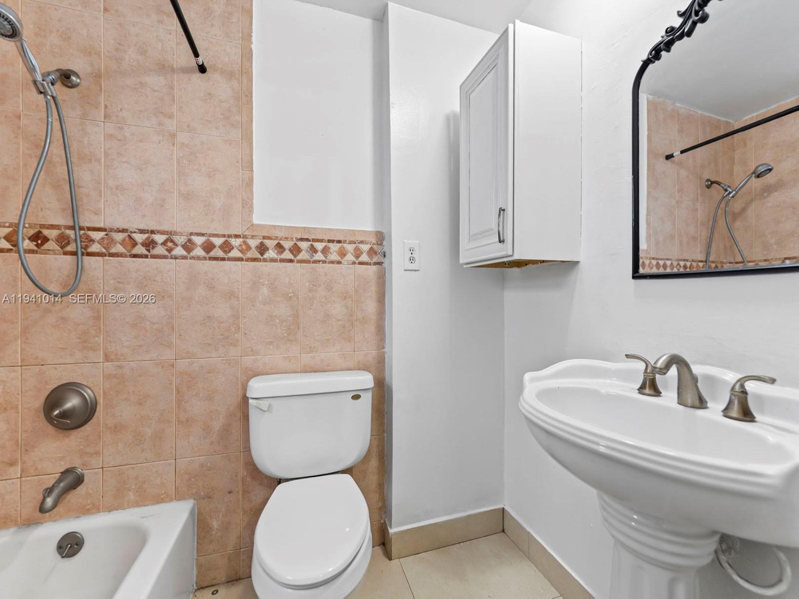 12301 Southwest 28th Street Miami, FL 33175 - Photo 39 of 46 a bathroom with a toilet sink and mirror