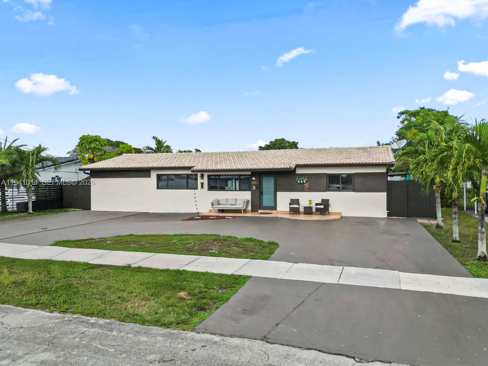 12301 Southwest 28th Street Miami, FL 33175 - Photo 7 of 46 a front view of house with yard and outdoor seating