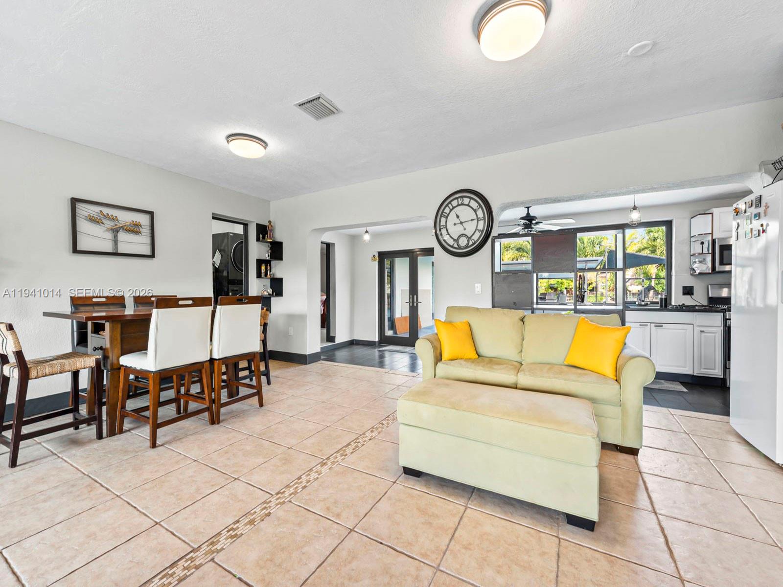 12301 Southwest 28th Street Miami, FL 33175 - Photo 10 of 46 a living room with furniture a clock and a large window