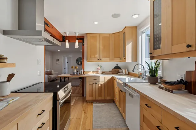 a kitchen with a sink stove and cabinets