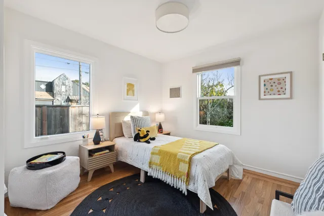 a bedroom with a bed and wooden floor
