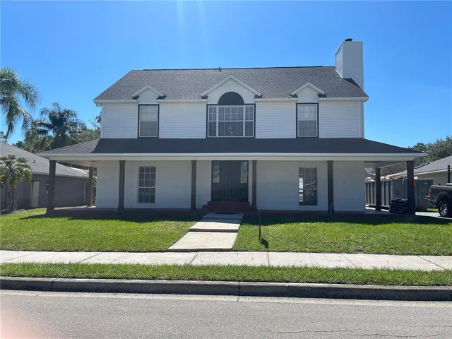 a front view of a house with a garden and yard