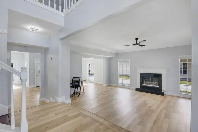 a view of an empty room with window and fire place