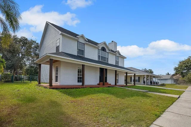 a front view of house with yard and green space