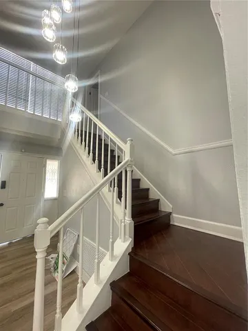 a kitchen with a sink cabinets and wooden floor