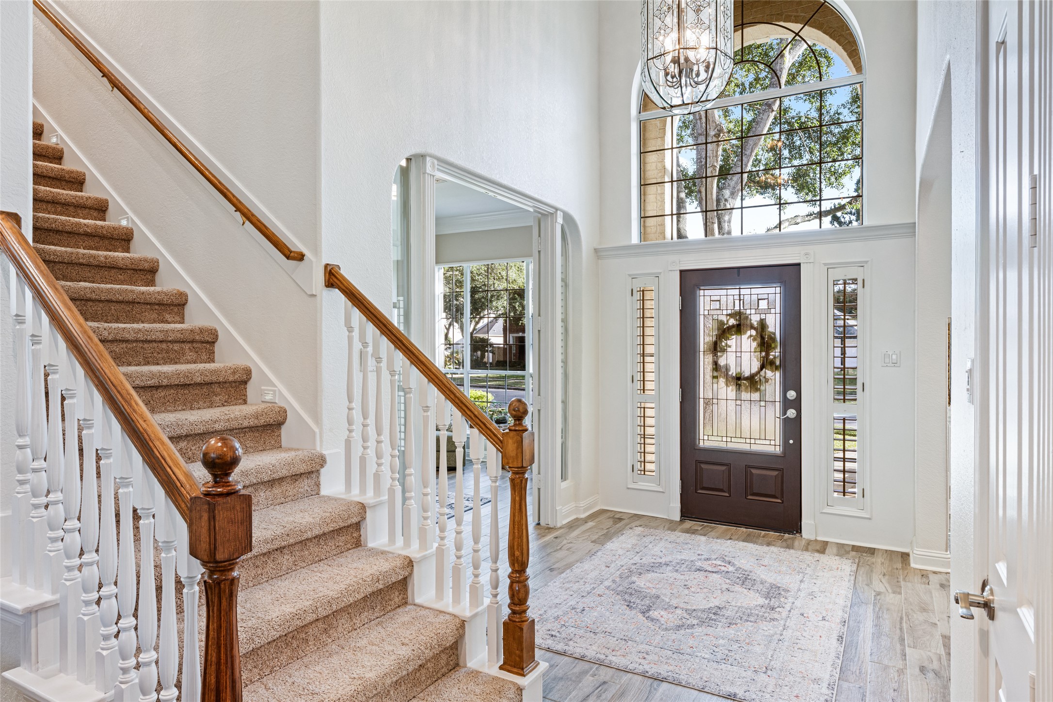 22806 2 Rivers Lane Katy, TX 77450 - Photo 14 of 49 Inviting two-story foyer with wood-look tile flooring and elegant staircase creates a grand first impression. A private study, home office, homeschool room or sunroom is located just off the entry, offering flexible space for today's lifestyle. Abundant natural light and open sightlines enhance the home's spacious and welcoming feel.